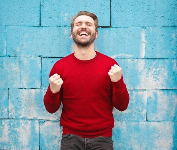 stock photo of guy in front of blue wall