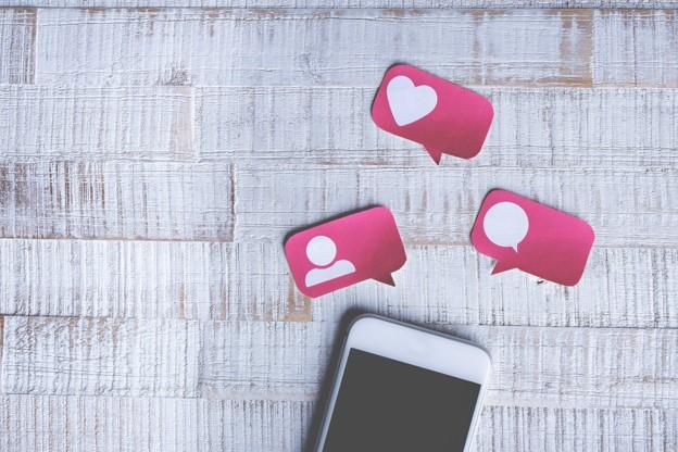 phone with likes and comment bubbles
